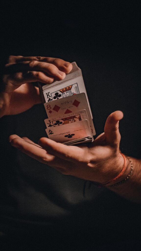 A close-up of hands skillfully performing a card trick with playing cards.